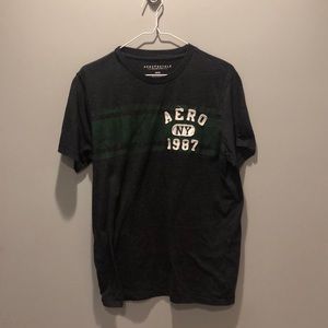 Men’s dark grey tee shirt with a green stripe